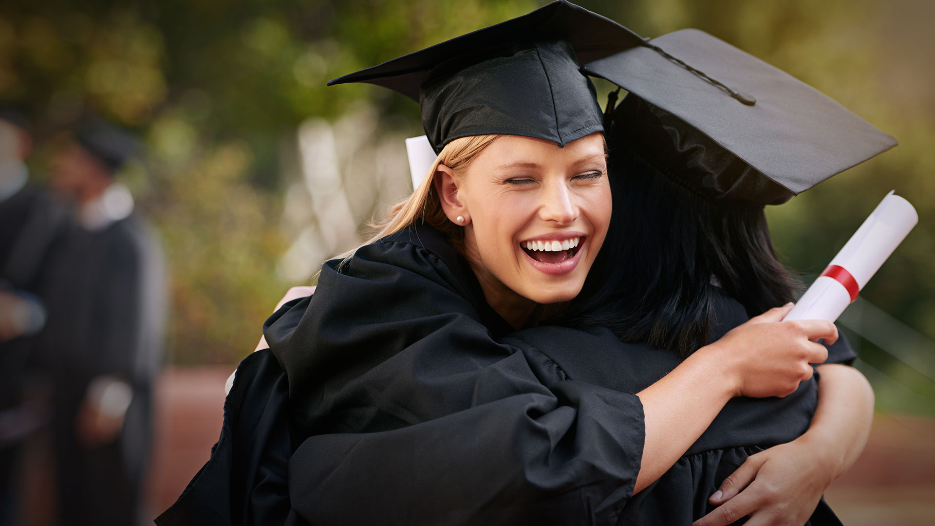 Students hugging at graduation