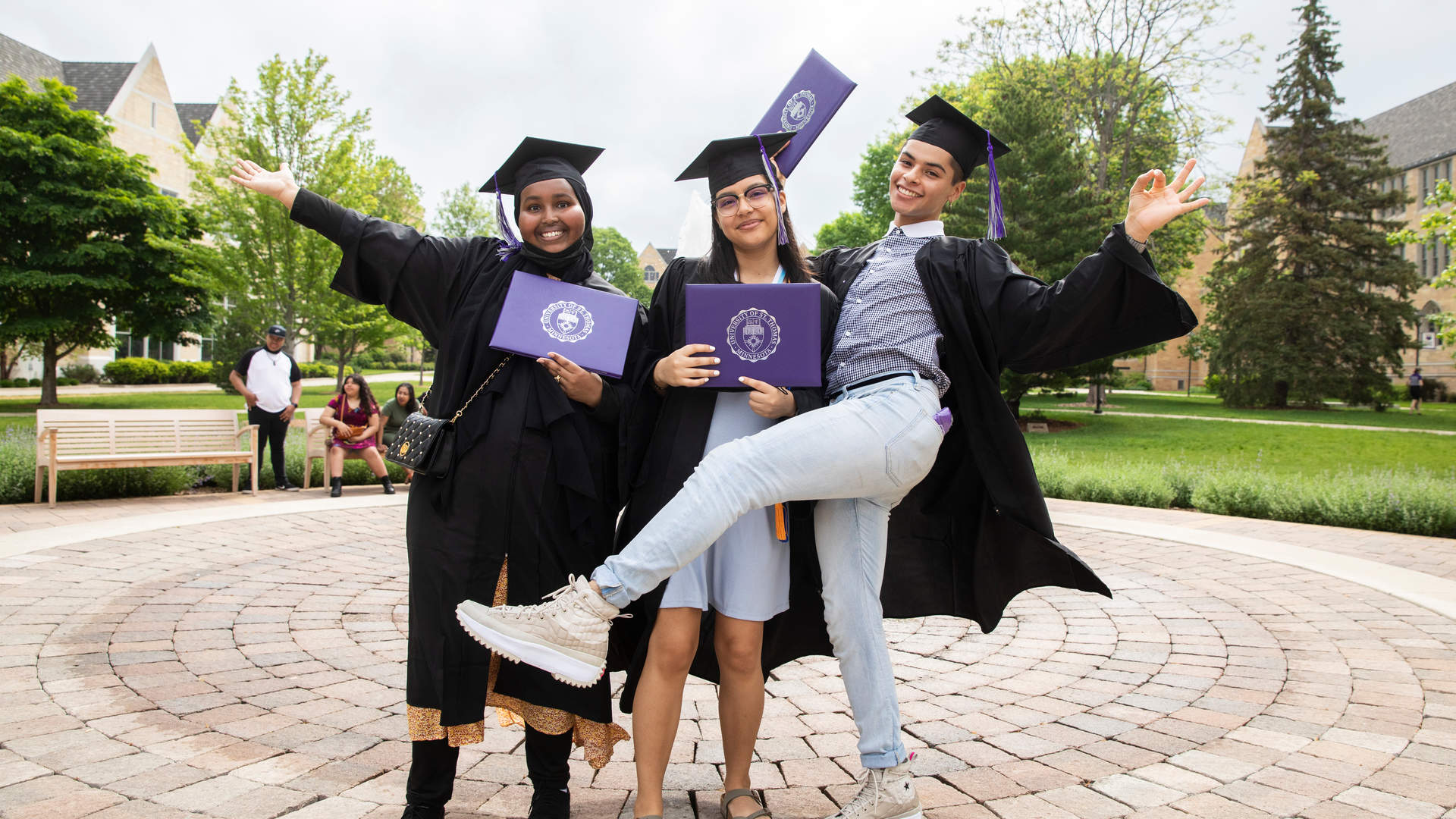 Three multicultural students at commencement