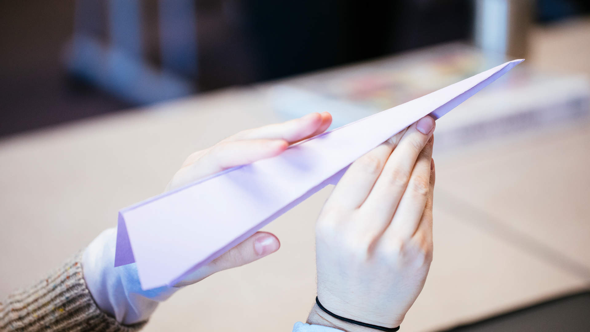 A student folds a paper airplane